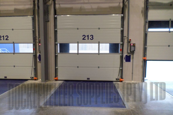 Insulated sectional industrial door with torsion spring balance, track options and integrated safety systems for commercial applications in South Africa.