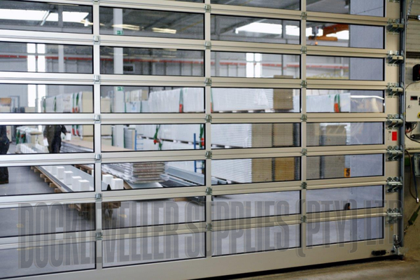High speed Sprint sectional door with rapid opening panels for industrial and commercial environments.
